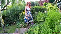 Mature redhead lifts up her dress and fingers herself outdoors